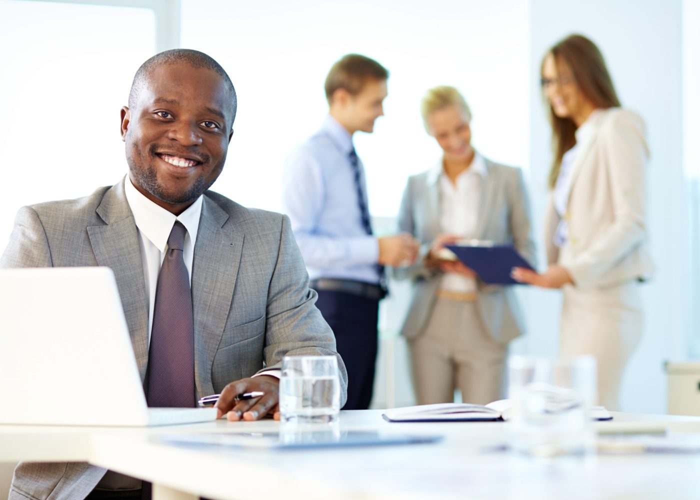 Portrait of a smiling businessman being at his workplace